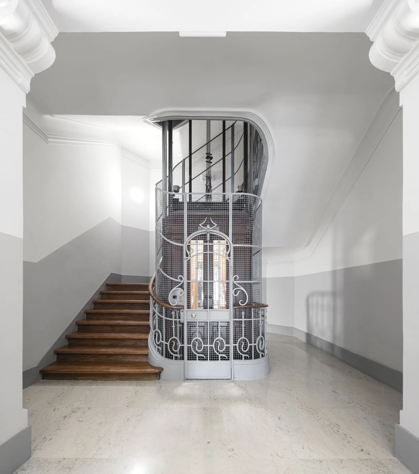 República 23 — restored Art Nouveau staircase and wrought-iron cage lift